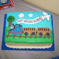Thomas Train Cake I made this cake for a friend's son's 2nd birthday. He is a huge Thomas the Tank Engine fan. The train cars, airplane, and tree...