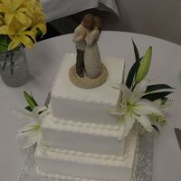 Samantha's Wedding Cake 6", 8" & 10". all white cake iced in bc. Bride provided the flowers and the topper. A pretty, simple cake to kick off...