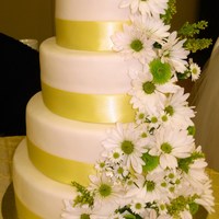 Fresh Daisies 4-tier cake with yellow ribbon and fresh daisies for a June wedding. WASC cake with almond buttercream and MMF. I had asked the bride to...