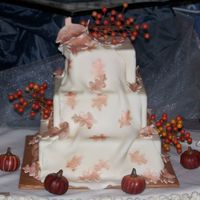 Fall Themed Wedding Cake This is a dummy cake I did for a bridal show. all is fondant with leaf imprints in fondant colored with luster dust.