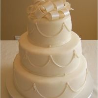 Wedding Cake With Bow Topper 12",9" and 6" fondant covered cake with bow topper.
