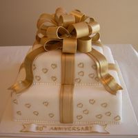 Golden Wedding Anniversary Cake Cake covered in fondant and gumpaste bow