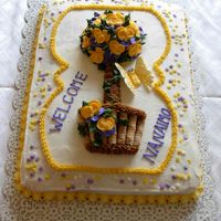 Topiary Welcome Cake WASC with buttercream and royal flowers. Basket is made with rolled wafer cookies. This was for a team visiting from out of town!