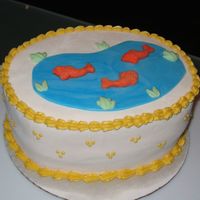 Fish Pond Cake MMF white with Wilton fondant for the fish, grass and marbled pond on an oval cake.