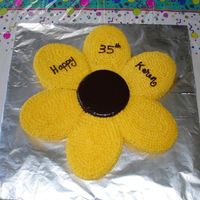 Flower Cake This was done for my friend's 35th birthday. It is 22 inches long and 7 cakes. The middle is a chocolate ganache and the yellow petals...