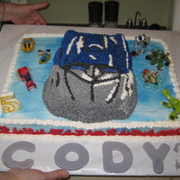 Optimus Prime My mom made this on a large sheet cake. We then put the character cake on top and decorated it. The flames are made out of color flow and...