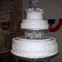Close Up Of 1St Wedding Cake Lots of mistakes....bulging of bottom layer, scroll work not centered, frosting not thick enough on sides and had shifting of top in...