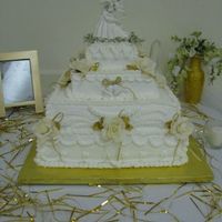 50Th Anniversary This was a replica of the couple original wedding cake with gold added for accents. All BC w/silk flowers. Photo frame to the side was a...