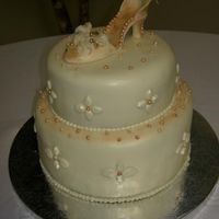 Shoe Cake This cake was done for a charity. It is vanilla cake with raspberry filling. Covered in fondant and decorated with gumpaste gems and a...