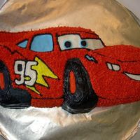 Car This cake was made a local charity race to beat cancer. It's white cake with buttercream. Based from the movie "Cars".