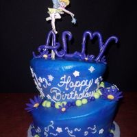 Tinkerbell Topsy turvy cake covered in CBC and airbrushed, with fondant accents and swirls piped on. Tink and name are made out of gumpaste and dusted...