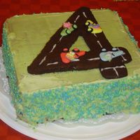 4Th Birthday Cake I made this cake for my stepson's 4th birthday. This cake combines all his favorite things: Racing cars, colors green and blue which...