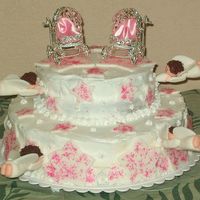 Angel Babies This is the cake I made for my twin daughters' baby dedication. In the baby carriages, I put pieces of pink satin so it would look...
