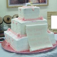 2005 Floral Graduation This cake has pink petunias and sweet peas. The scroll in front is made of fondant and we did not make it far enough in advance. It has...