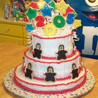 2005 Graduates The year, the stars, and the graduates are all sugar cookies. The graduates are all holding candy diplomas and wearing candy caps.