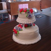 Wilton Course 3 Final Bottom is yellow with strawberry cream filling, BC icing and fondant flowers. Top is chocolate with raspberry filling and fondant flowers....