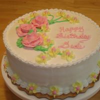 First Official Cake Yellow and chocolate alternating layers with raspberry jam inbetween. BC icing and decorations. This is my first "paid" order....