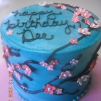 Cherry Blossoms On Teal Cherry blossom cake on teal background. Blossoms made from fondant, covered with SMBC.