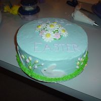 Happy Easter Easter cake for the family. Yellow cake, BC frosting, fondant bunnies, royal icing flowers and mini eggs on sides.