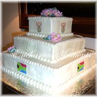 South African creamcheese frosting with sugarpaste flowers and fondant dec.Groom was from south africa