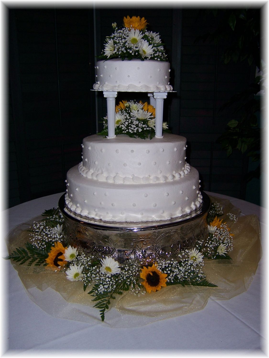 Sunflower_Simply_Devoted.jpg three tiered buttercream cake with fresh sunflowers and daisys