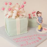 Baby Shower Lemon cakes with chocolate fondant, clay pearls and fondant/gumpaste figure. Gumpaste bow. The poor woman has swollen *cankles* (calves...