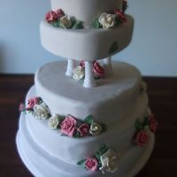 Roses And Monogram A wedding cake for 100 people with roses and a mongram on the top.