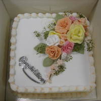 Birthday Cake A fruit cake covered in fondant icing topped with sugarpaste roses and blossom.