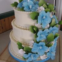 Hawaiian Wedding Gumpaste Hibiscus, fruit blossoms and leaves. Buttercream frosting over vanilla cake