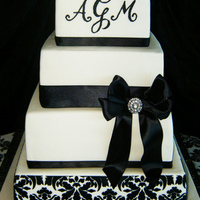 Black And White Damask Piping done with royal icing. Damask is with stencil. Ribbon is satin.