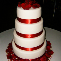 Red And White Wedding Cake A simple red and white design. Satin ribbon. Real rose petals.