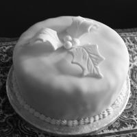 White Holly Christmas Cake round fruit cake decorated all in white with white holly and piping