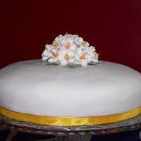 Orange Blossom Cake ivory icing orange blossom and orange ribbon