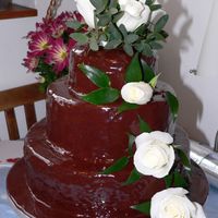 Chocolate With White Roses A three tier wedding cake with chocolate fudge icing and real white roses