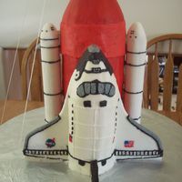 Space Shuttle Chocolate cake with raspberry pear filling for the main engine. WASC with raspberry filling for the shuttle and card board tubes covered in...