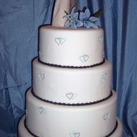 Intertwined Hearts Chocolate cake with white truffle ganache filling. Royal icing hearts. Fondant oval pearl border