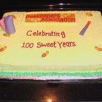 State Bee Club's 100Th Anniversary Chocolate cake with faux fondant icing. Bees, hive tool and smoker make from fondant.