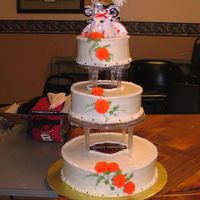 Harley Davidson Wedding Cake Simple white cake with icing in the middle. Roses made with buttercream. FBCT Harley logo on the two lower levels. Small black hearts...