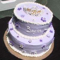 Baby Shower Cake Stacked cake with lavendar icing. Flowers are made from fondant and tiara made from royal icing. Cake was white and chocolate.
