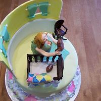 Another View: Baby Shower Cake For Pro Football Wife Bird's eye view. You can see the football here. as a nod to dad, as well as a a litte more of mom's detail. I sculpted mom from a...