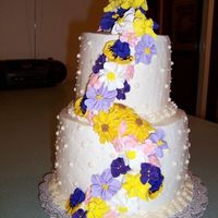 My First Wedding Cake I deliberately collared the cake pans in order to obtain more height for each layer. The cake is frosted in buttercream. The flowers are...