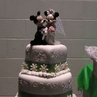 Mickey & Minnie Wedding Fondant Covered, mixed tier wedding cake with scroll work. Lime Green satinribbon, Fondant Daises and Mickey/Minnie Topper.