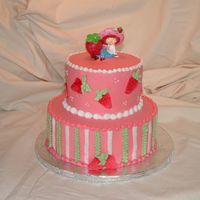Strawberry Shortcake Frosted in buttercream with buttercream piping and fondant strawberries.
