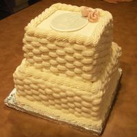 Pict0037.jpg Two tier, four layers each. Lemon cake with raspberry and BC filling. Iced with BC