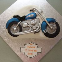 Harley This was made using the Wilton motorcycle cake pan. Some fondant was modeled and place on the cake before covering with fondant, and some...
