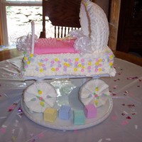 Baby Buggy from a Wilton book - baby shower cake. Wheels are 4" cookies, with pillars behind them. Hood is made from royal icing which was formed...