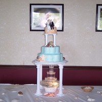 Beach Wedding Cake Vanilla cake, top tier covered in bc with sand colored sugar for beach, blue tiers for water. Gun paste shells mixed with real sea shells...