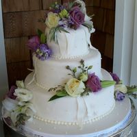 Lavender & Pearls Three tiers of white cake with Orange Zest BC filling. Satin Ice Fondant and sugar pearls accented with fondant ribbontails and fresh...