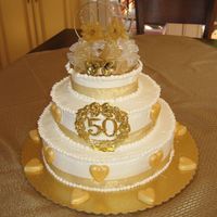 My Parent's 50Th Anniversary I made this cake for my parents 50th anniversary party. The gold hearts are molded from candy melts and then dusted with gold dust. I made...