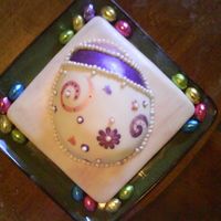 Ostara Cake This is a simple yellow cake, with fondant. The egg on top is painted with luster dust, and the pearls are fondant with pearl luster dust....